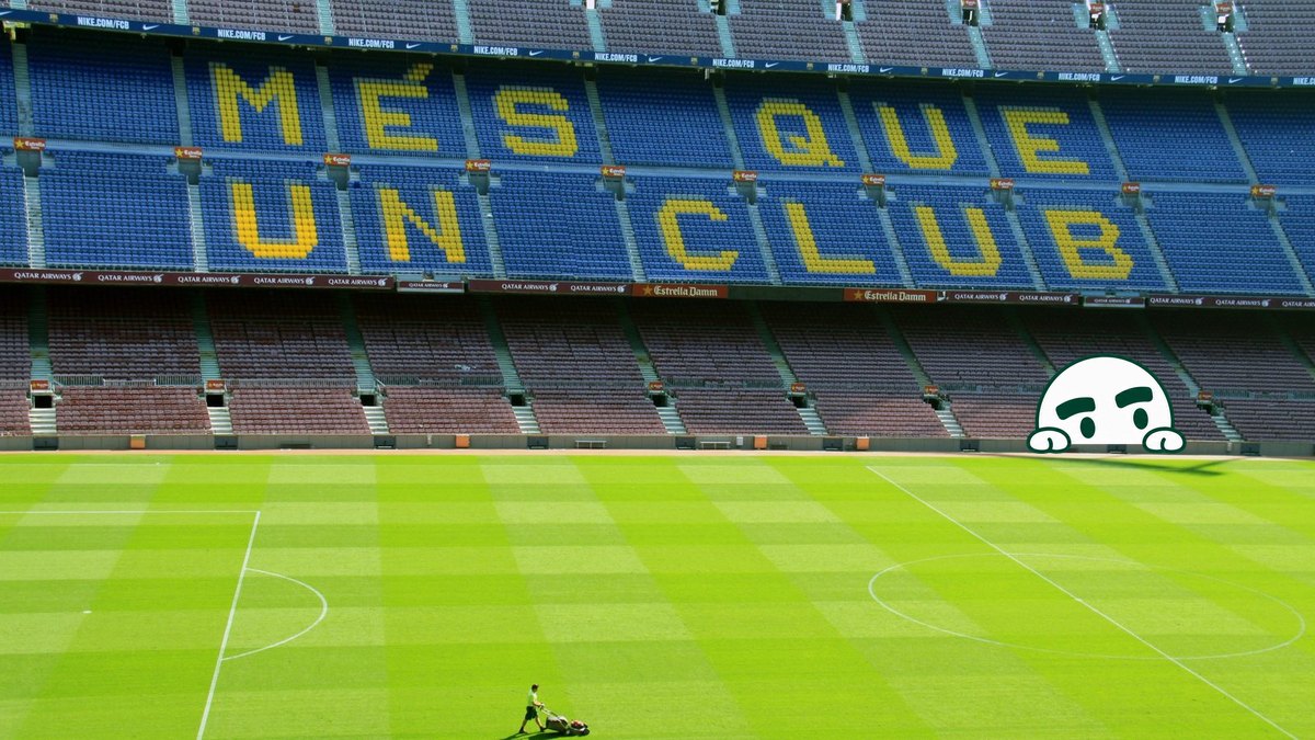 A groundsman mows the empty pitch at Camp Nou, below seats spelling Més que un club.